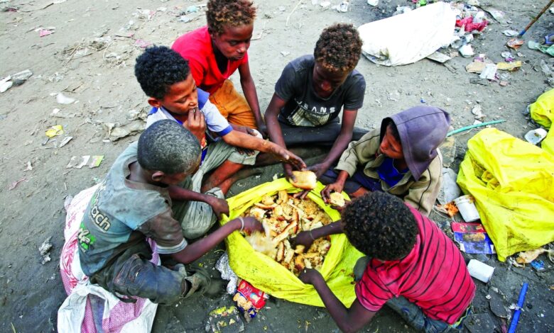 boys eat bread they collected from a garbage dump on the outskirts of the red sea port city of hodeida